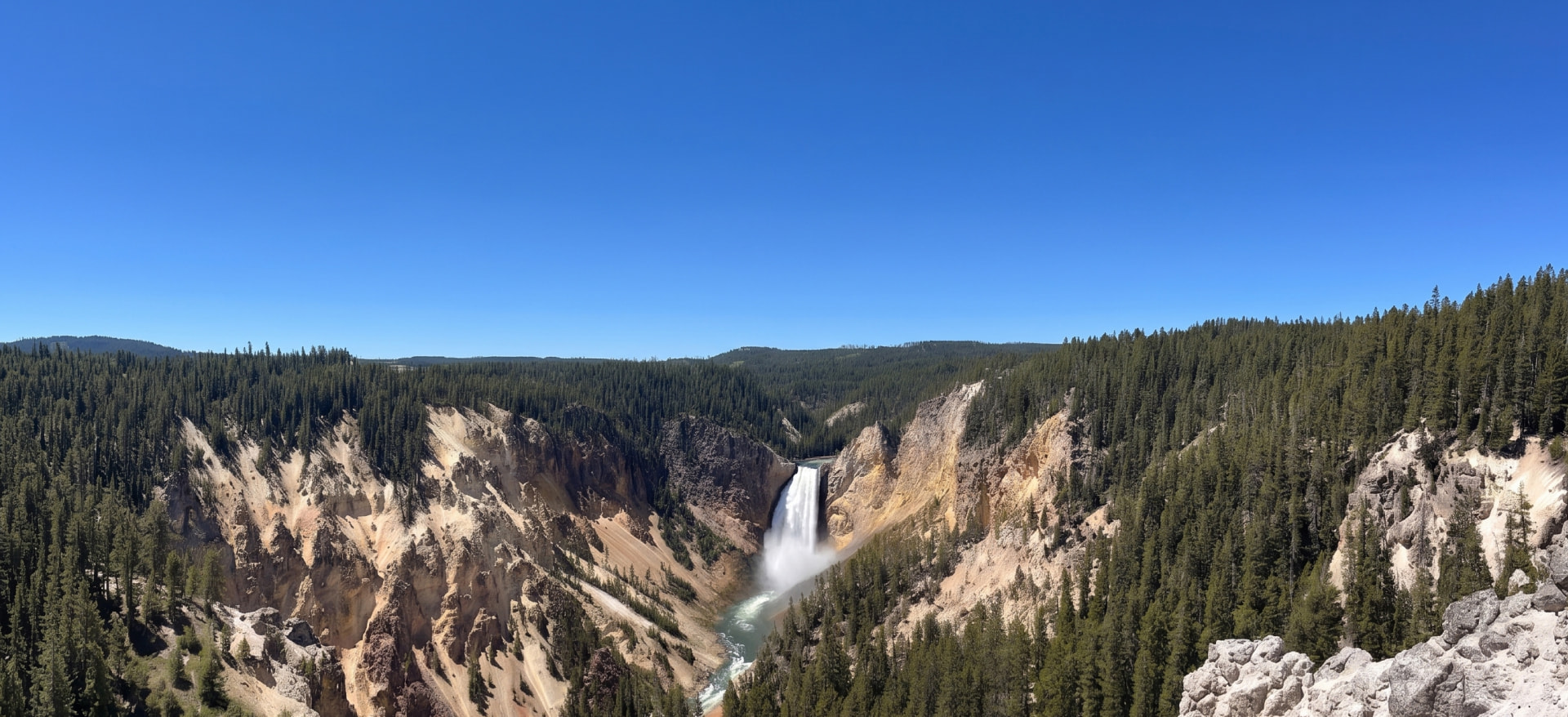 A waterfall in a forested Montana canyon
